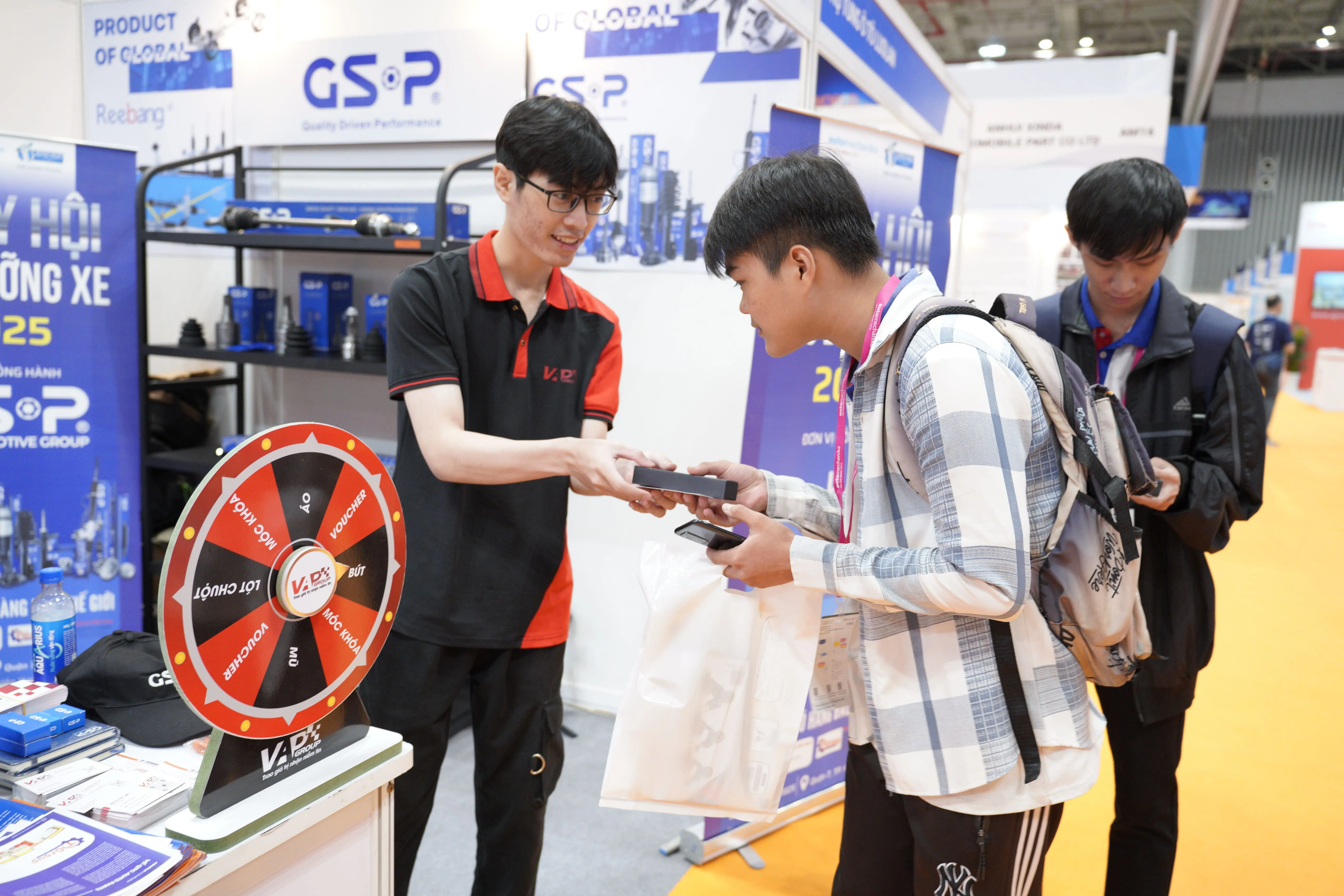 Cán bộ VAPGroup tặng quà cho khách quam quan check-in fanpage Vietnam Auto Parts Group